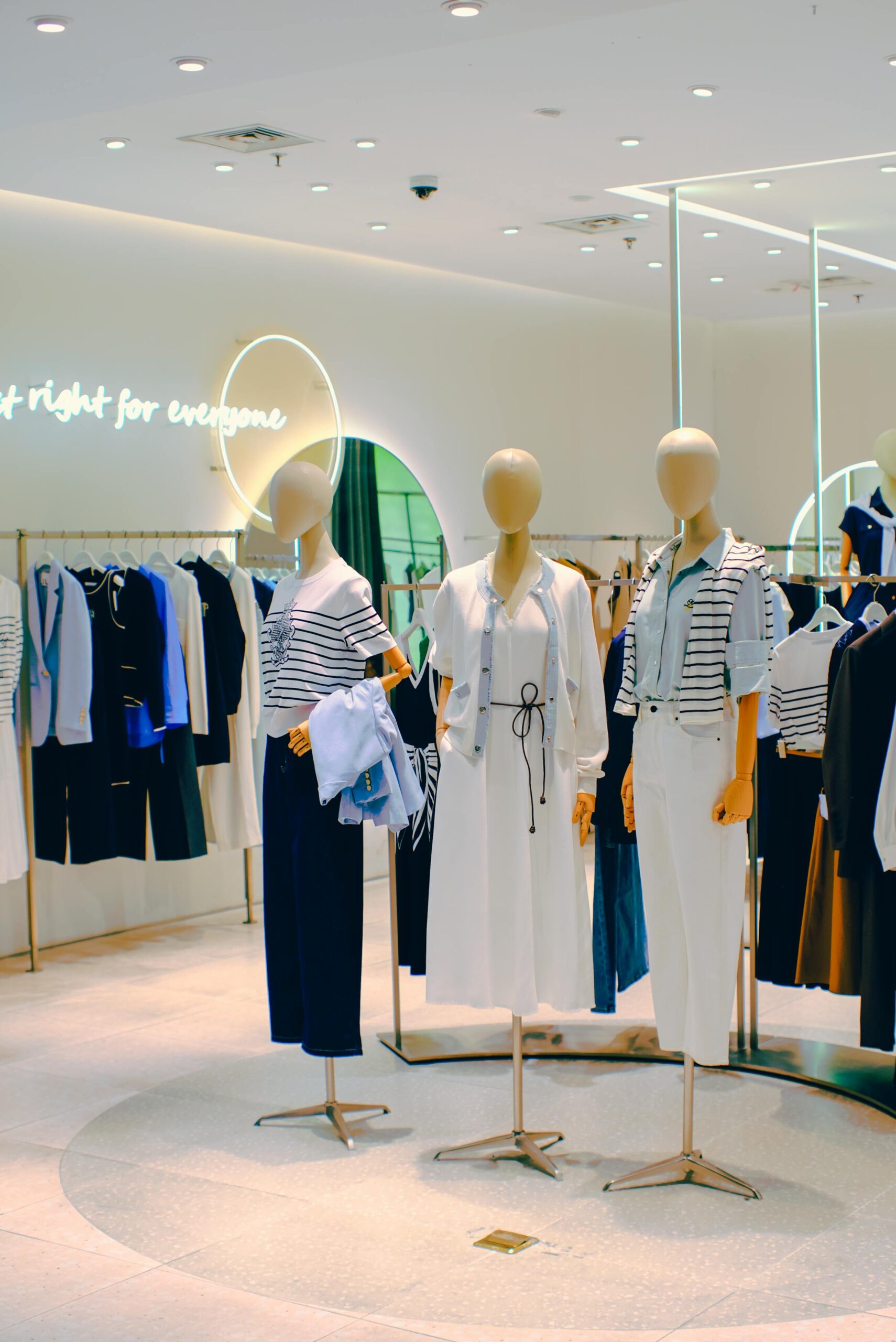 Chic clothing store interior with stylish mannequins. Elegant fashion display for retail inspiration.